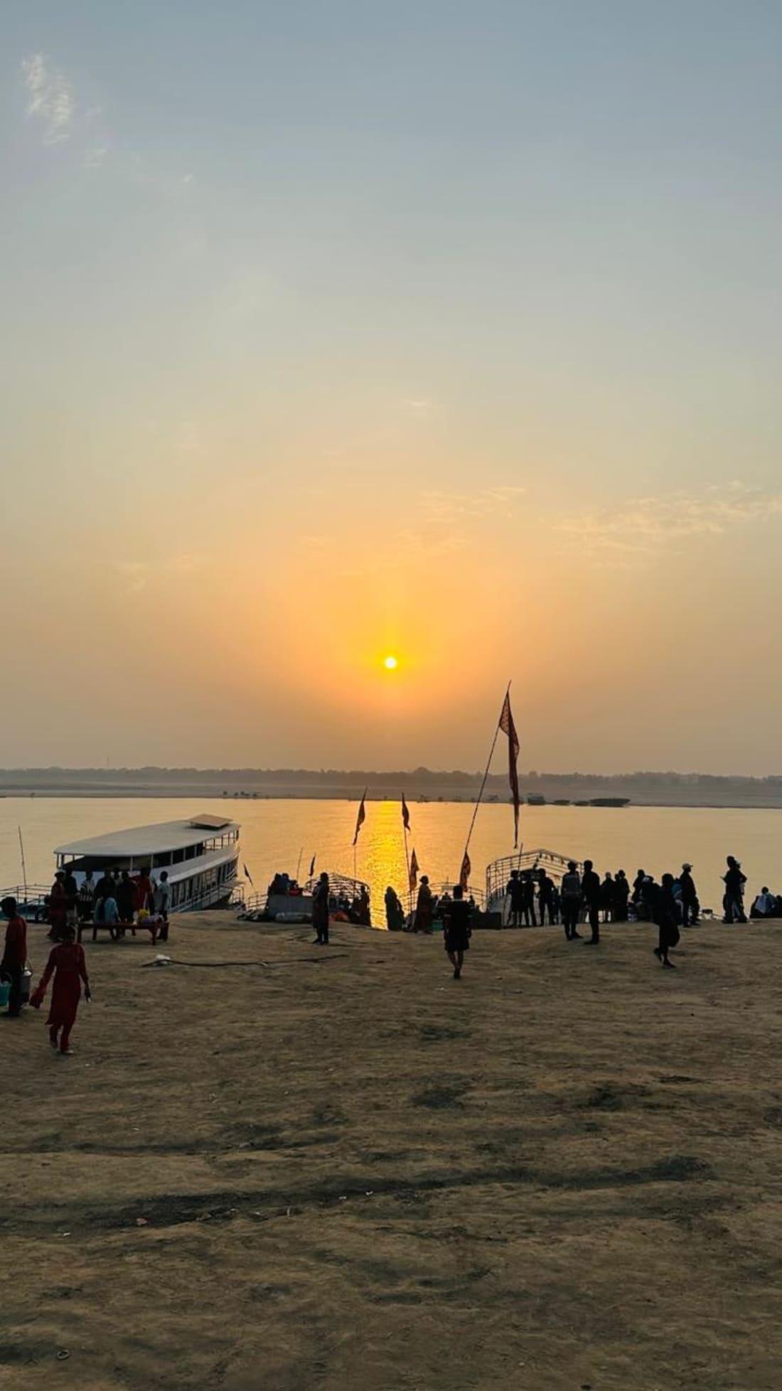Sunrise over the Ganges at Assi Ghat, with boats at the riverfront